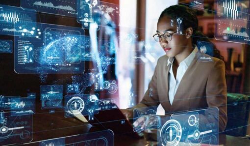 Woman in tan suit working on remote AV monitoring