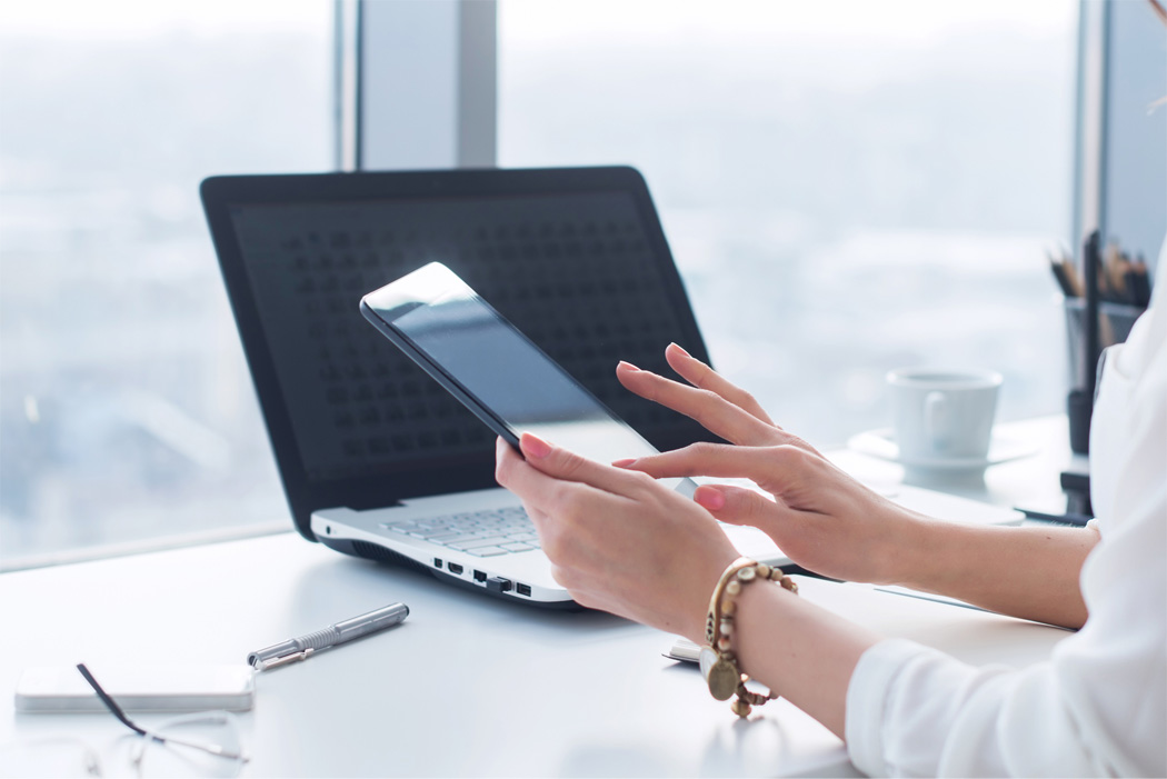 Woman with personal laptop and phone